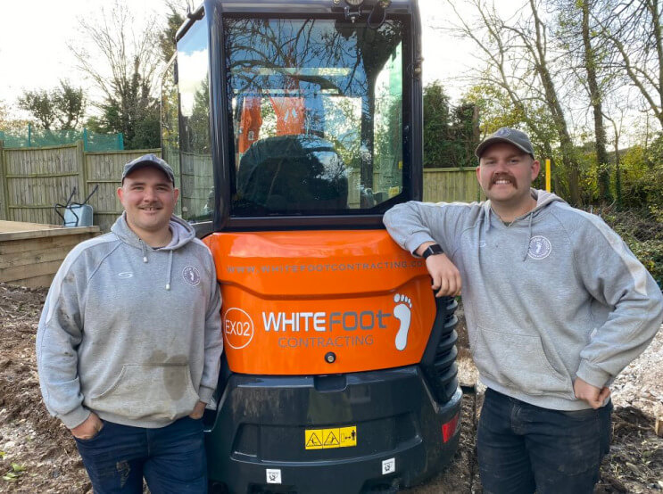 Two members of the Whitefoot team stood next to a whitefoot digger.